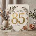 Cartão Elegant Gold Botanical Wreath Womens 85th Birthday<br><div class="desc">Celebrate a beautiful milestone with this elegant women's 85th birthday card. Featuring stunning faux 3D gold numbering surrounded by a delicate botanical wreath of sage green leaves and dusty rose flowers, this elegant greeting card is perfect for a mother, grandmother, or dear friend. The textured cream background and beautiful script...</div>