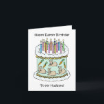 Cartão Felz pascoa BIrthday Husband<br><div class="desc">Uma ilustração de um bolo de aniversário branco decorado com velas iluminadas e imagens de coelhos e cenouras ao redor dos lados. As palavras "Felz pascoa Aniversário ao Meu Marido" acompanham a imagem.</div>