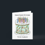 Cartão Felz pascoa BIrthday Husband<br><div class="desc">Uma ilustração de um bolo de aniversário branco decorado com velas iluminadas e imagens de coelhos e cenouras ao redor dos lados. As palavras "Felz pascoa Aniversário ao Meu Marido" acompanham a imagem.</div>