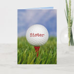 Cartão Golf Ball On Tee for Sister<br><div class="desc">Feche a bola de golfe no chá vermelho na grama verde para o aniversário da Irmã. O texto na bola pode ser editado.</div>