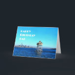 Cartão Happy Birthday Dad Over Ocean Lighthouse Card<br><div class="desc">A strong sturdy lighthouse watches over the city in the foreground. in the background it's a nice sunny day and lovely blue skies with the odd cloud in the sky. This birthday card is the perfect,  cheerful and inspiring way to celebrate the birthday of a father. Happy Birthday Dad!</div>