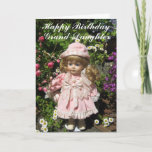 Cartão Happy Birthday Grand-daughter<br><div class="desc">Happy Birthday Grand-daughter text with pretty little doll,  dressed in pink amidst floral background</div>