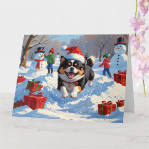 Cartão Japanese Chin Correndo na Neve com Chapéu de Natal