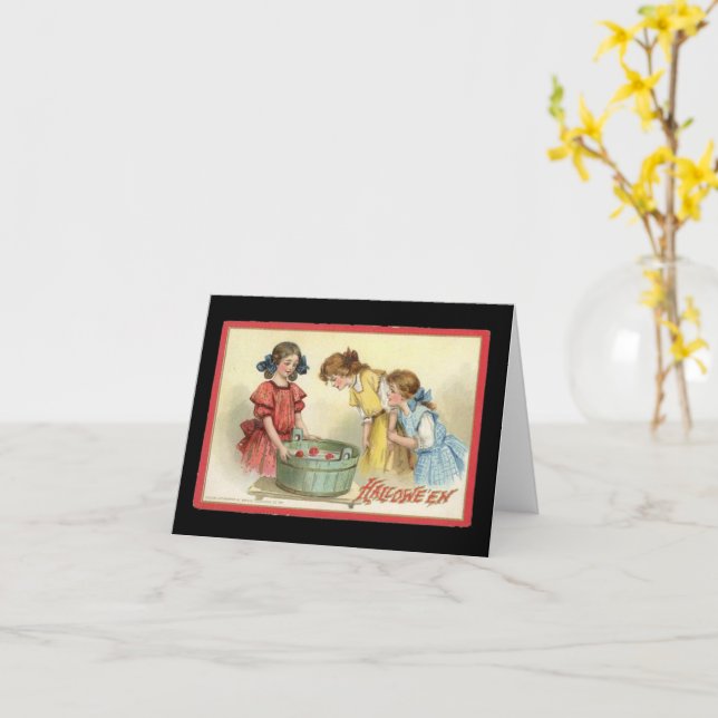 Cartão Meninas do Halloween Mergulhando em busca de Maçãs (Flor Amarela)