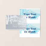 Cartão Metalizado Lobo Solitário No WInter<br><div class="desc">Um lobo (Canis lupus) percorre uma paisagem nevada de pássaros e montanhas nesta imagem estilizada,  de monotone azul. Leitura de texto,  "Feliz Natal" também aparece. Adicione seu próprio texto adicional.</div>