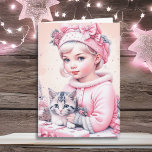 Cartão Paz esteja com você e seu | Natal<br><div class="desc">Cartão de Natal bonito. Adorável menina vintage no boné de inverno com flores cor-de-rosa segurando um gatinho com cinza listrada.</div>