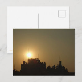 Cartão Postal Black against the golden glow of the setting sun.