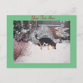 Cartão Postal cena de neve de inverno de um cão preto e bronzead