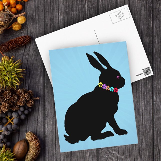 Cartão Postal Coelho Negro sentado em flores Bonito da silhueta (Black silhouette sitting Easter or Spring Time rabbit wearing flowers on blue postcard.)