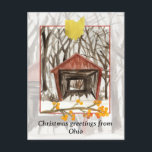 Cartão Postal De Festividades Feliz Natal da ponte coberta de Ohio Winter<br><div class="desc">Feliz Natal de Ohio com uma ilustração de aquarela inspirada na ponte de Hizey, no Condado de Fairfield, em uma paisagem de neve com árvores altas, acentuadas com um galho de winterberry ouro e a forma estadual pintada com aquarela. Excelente modo de enviar desejos de feriado para amigos, familiares, amigos...</div>