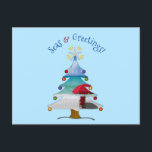 Cartão Postal De Festividades Seas and Greetings Photo Beach Christmas<br><div class="desc">Wish them Seasons Greetings this holiday season with this funny and cute photo blue beach Christmas card with the greeting, "Seas & Greetings" in arched font featuring a white sandy beach, red beach umbrella, and seascape inside of a whimsical Christmas tree! Inside of the card features your photo, and the...</div>