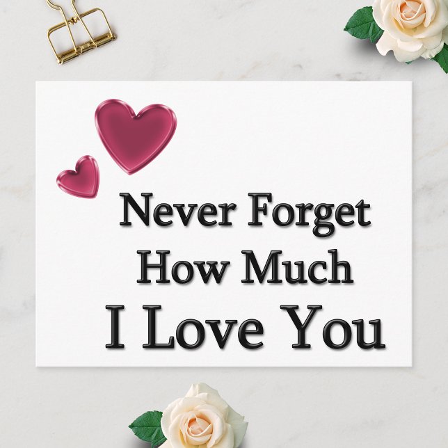 Cartão Postal Eu Te Amo (Postcard showing Never Forget How Much I Love You with two hearts, laid flat on a white surface.)