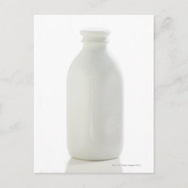 Cartão Postal Milk bottle on white background