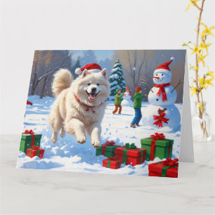 Cartão Samoyed Correndo na Neve com Chapéu de Natal
