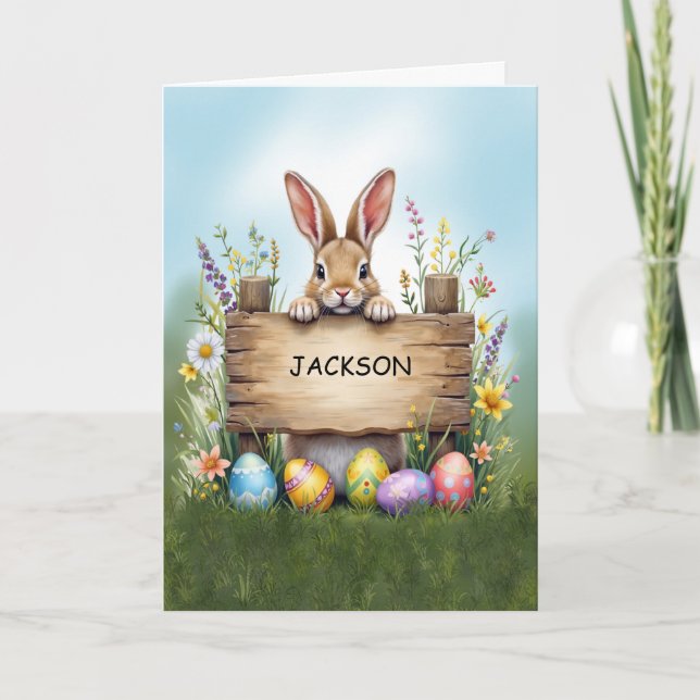 Cartão Sinal russo coelho em grama com ovos de Páscoa (Frente)