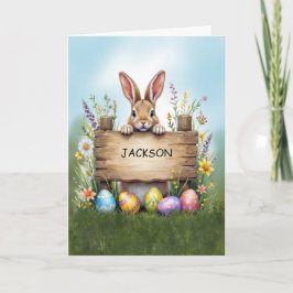 Cartão Sinal russo coelho em grama com ovos de Páscoa