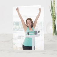 Successful weight loss. Happy woman weighing