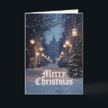 Cartão Village Winter Scense Feliz Natal<br><div class="desc">A cena de inverno da vila medieval é um cartão de boas-vindas de Natal. Uma grande passagem iluminada por luzes de rua cria um brilho mágico na neve caindo. À distância, é visível um fogo catedral. A mensagem dentro lê Warm Wish to You & Yours (Desejo Caloroso a você e...</div>