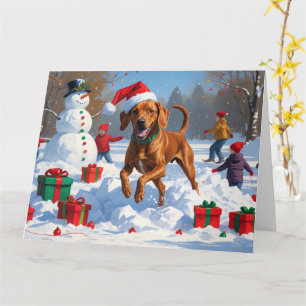 Cartão Vizsla Correndo na Neve com Chapéu de Natal