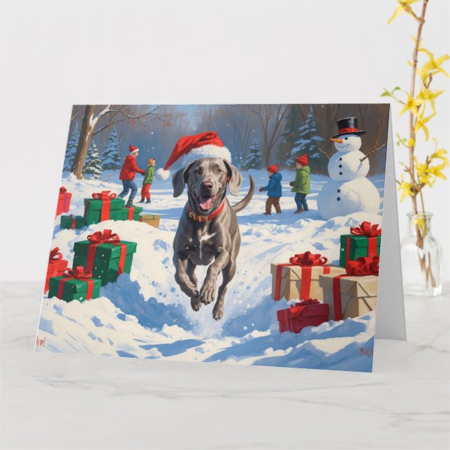 Cartão Weimaraner Correndo na Neve com Chapéu de Natal (Flor Amarela)
