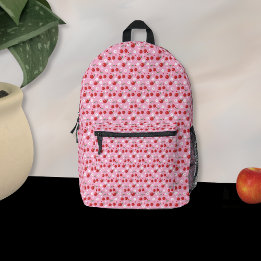 Cerejas e mochila cor-de-rosa com flores pequenas
