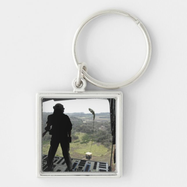 Chaveiro Avião assiste a queda de um pacote de prática (Frente)