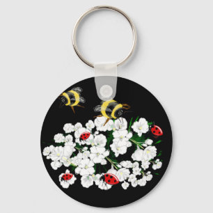 Chaveiro Bebês-frade e flores brancas em preto