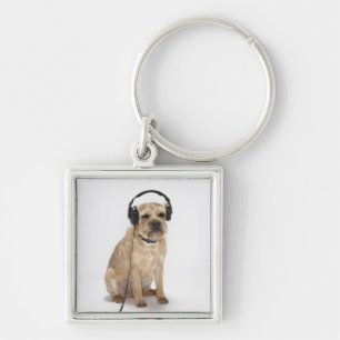 Chaveiro Cão pequeno que veste fones de ouvido