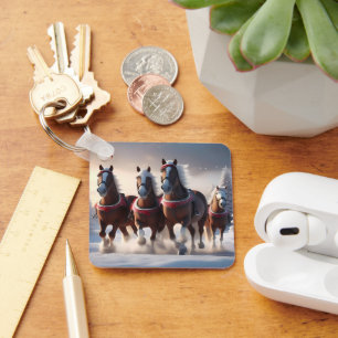 Chaveiro Galopando pela neve: Cavalos Mágicos dos Papais no