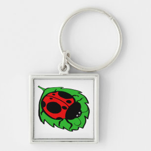 Chaveiro Ladybug sorridente numa Folha Verde