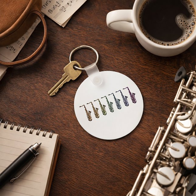 Chaveiro Linha de Saxofone Tenor Arco-íris (A keychain with a rainbow lineup of tenor saxophones.)