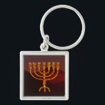 Chaveiro Moshe's Menorah<br><div class="desc">Na Torah Moshe Rabbenu, diz-se, "Você fará um Menorah de ouro puro, espancado, se o Menorah for feito, sua base, seu galho, suas bolas, seus botões, e suas flores serão martelados dele, " [Shmot 25:31] e mais tarde, "Veja, construa, de acordo com a forma que você está mostrando na montanha."...</div>