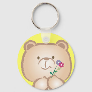 Chaveiro o urso fêmea traz flores