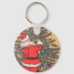 Chaveiro Papais noeis decorando a árvore de Natal