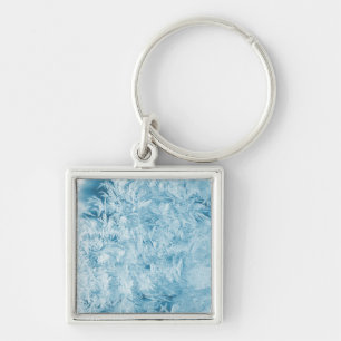 Chaveiro penas azuis abstratas e flocos de neve