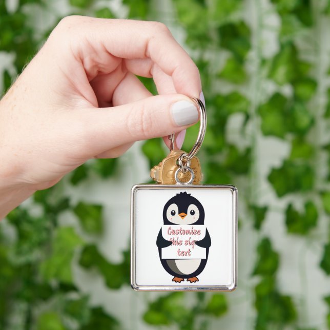Chaveiro Pinguim fofo segurando um sinal para texto persona (Mão)