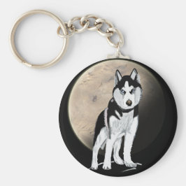 Chaveiro Rouco preto e branco dramático contra a lua cheia