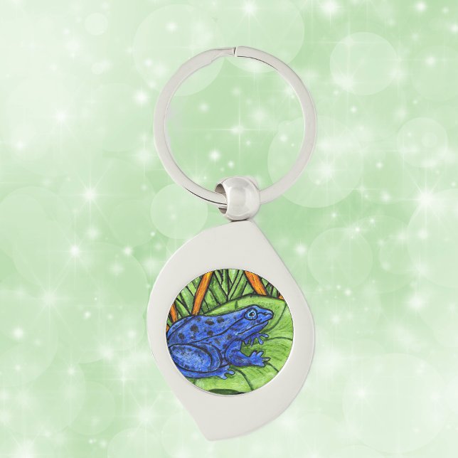 Chaveiro Sapo Vibrante de Veneno Azul (Blue poison Frog on green lily pad with yellow reeds grass on keychain.)
