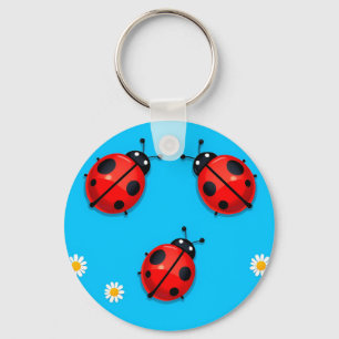 Chaveiro Três besouros coloridos em um fundo azul