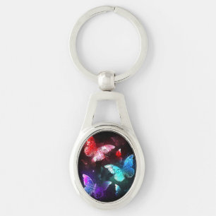 Chaveiro Três Borboletas brilhantes sobre o fundo noturno