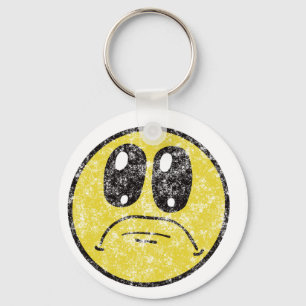 Chaveiro triste dos desenhos animados da cara do