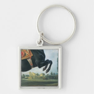 Chaveiro Um cavalo preto que executa o Courbette