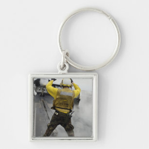 Chaveiro Um diretor dos aviões sinaliza um zangão de