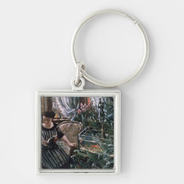 Chaveiro Uma mulher que lê perto de um tanque do peixe (Frente)