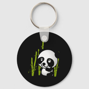 Chaveiro Urso panda branco e preto num pomar de bambu.