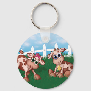 Chaveiro Vacas-bebê do lado de morro com cerca branca no f