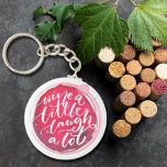 Chaveiro Vinho Ria Muito<br><div class="desc">O chaveiro de botão redondo apresenta texto divertido "Wine a Little Laugh A Lot" em uma mancha de vinho tinto. Chaveiros fazem presentes memoráveis para familiares e amigos ou criam por si mesmos.</div>