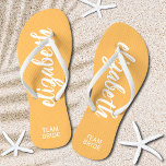 Chinelos Noiva de Equipe Personalizada Laranja e Branco<br><div class="desc">Laranja claro e branco - ou qualquer cor - chinelos personalizados com seu nome e "Noiva de Equipe" ou qualquer texto que você escolher. Excelente noiva, festa de solteira, calçados planos para a recepção de casamento ou um favor divertido para o chá de panela. Mude as tiras de cor e...</div>