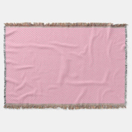 Cobertor A pink woven blanket with a subtle pattern 