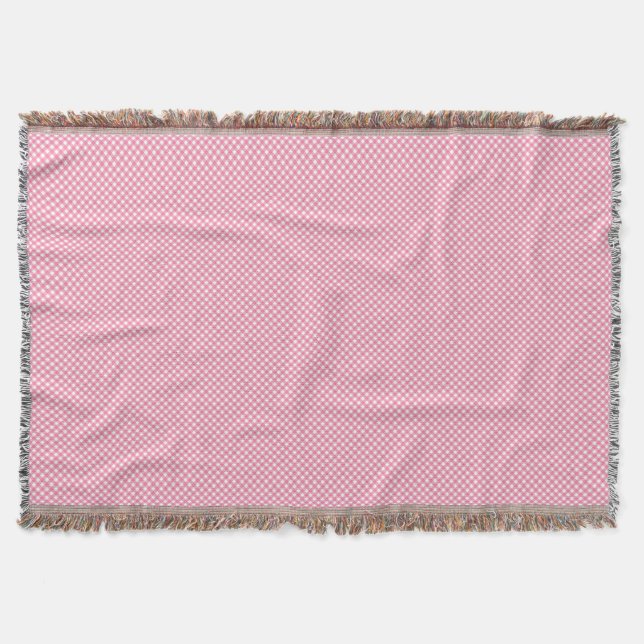 Cobertor A pink woven blanket with a subtle pattern  (Frente)
